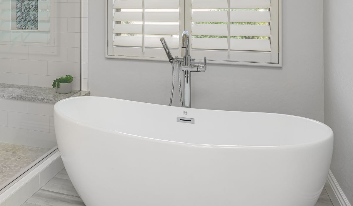 White bathtub with freestanding faucet